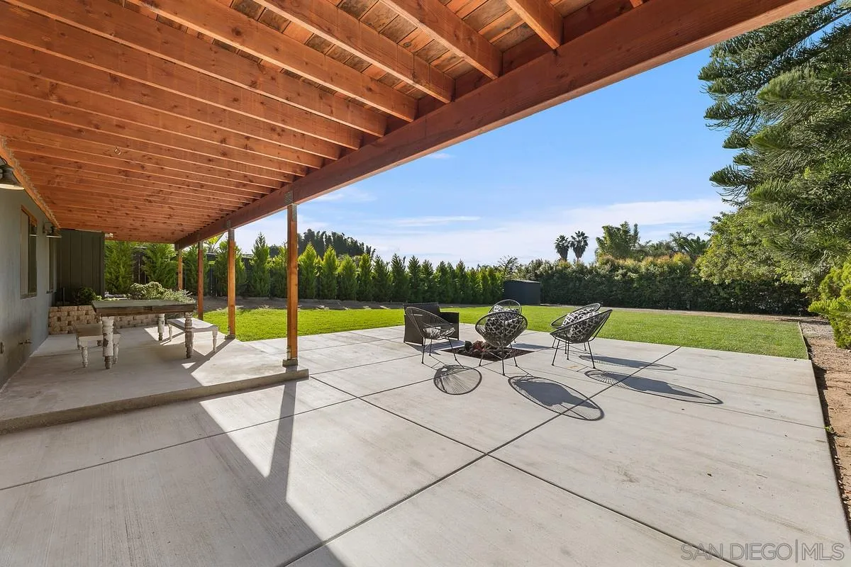 970 Saxony Road Encinitas, CA 92024 - Photo 24 of 39 a view of a patio with a table and chairs under an umbrella