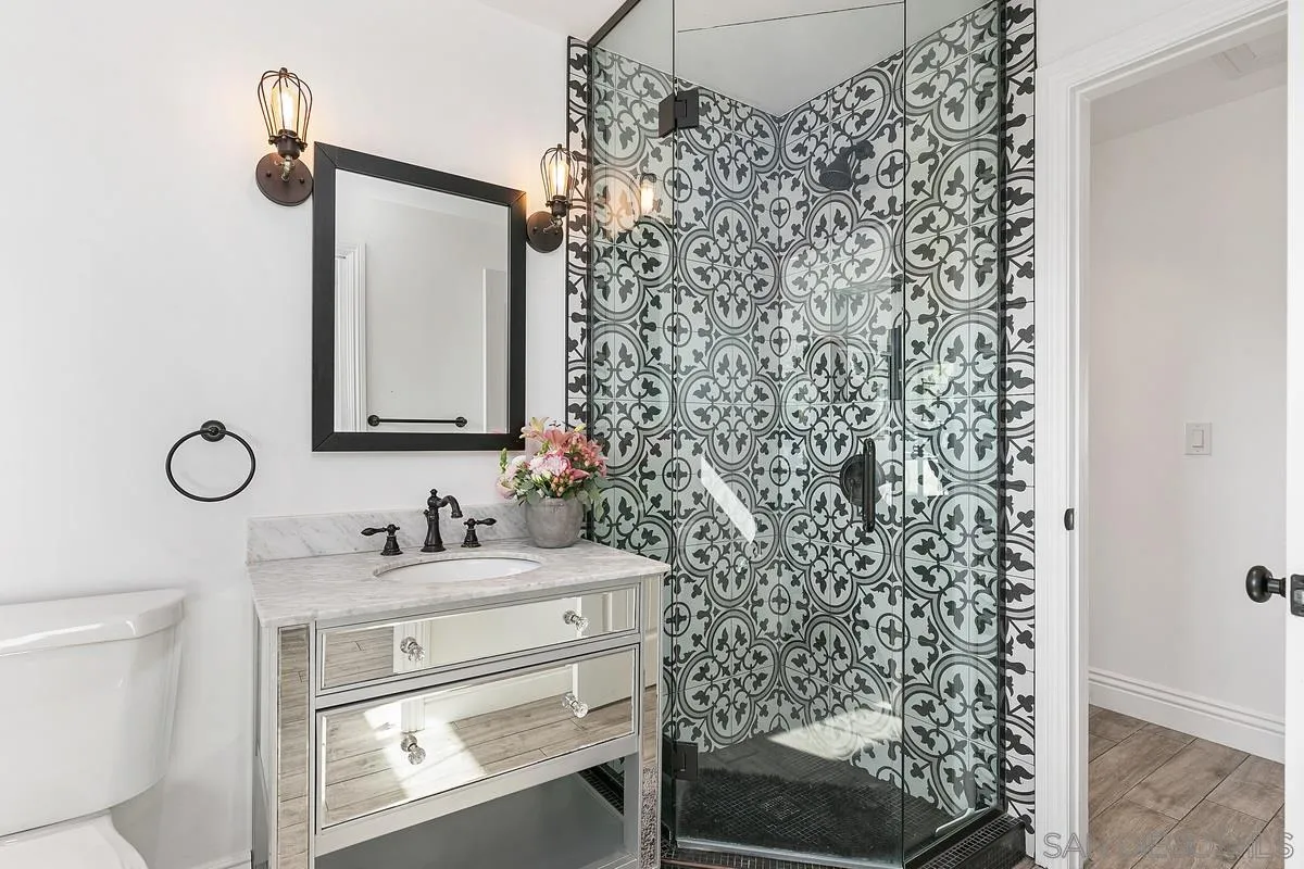 970 Saxony Road Encinitas, CA 92024 - Photo 27 of 39 a bathroom with a sink a toilet and shower