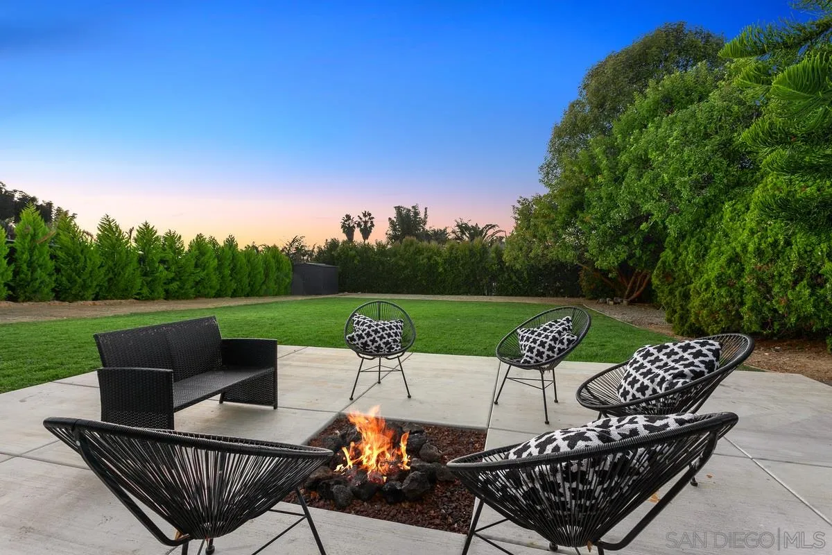 970 Saxony Road Encinitas, CA 92024 - Photo 4 of 39 a view of a patio with couches chairs potted plants and a yard