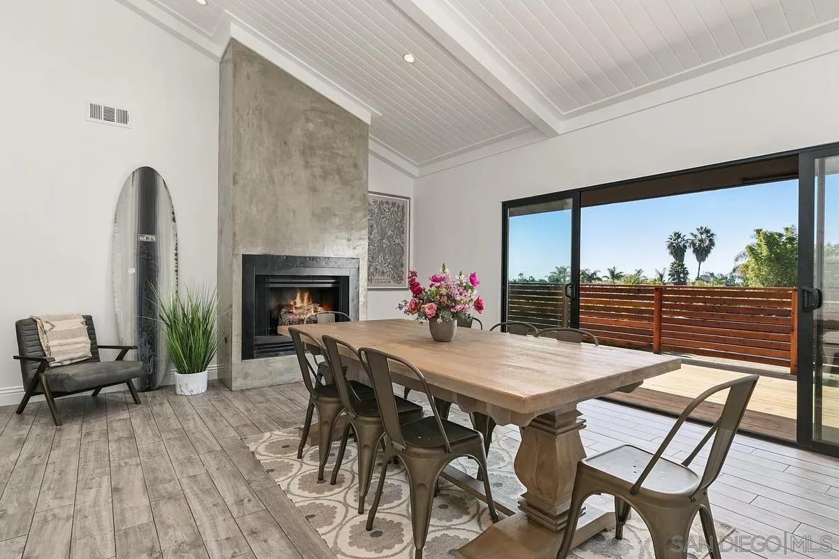 970 Saxony Road Encinitas, CA 92024 - Photo 7 of 39 a view of a dining room with furniture window and wooden floor