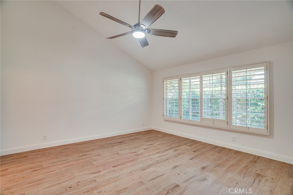 49 East Yale Loop, Unit 26 Irvine, CA 92604 - Photo 32 of 63 an empty room with wooden floor and windows