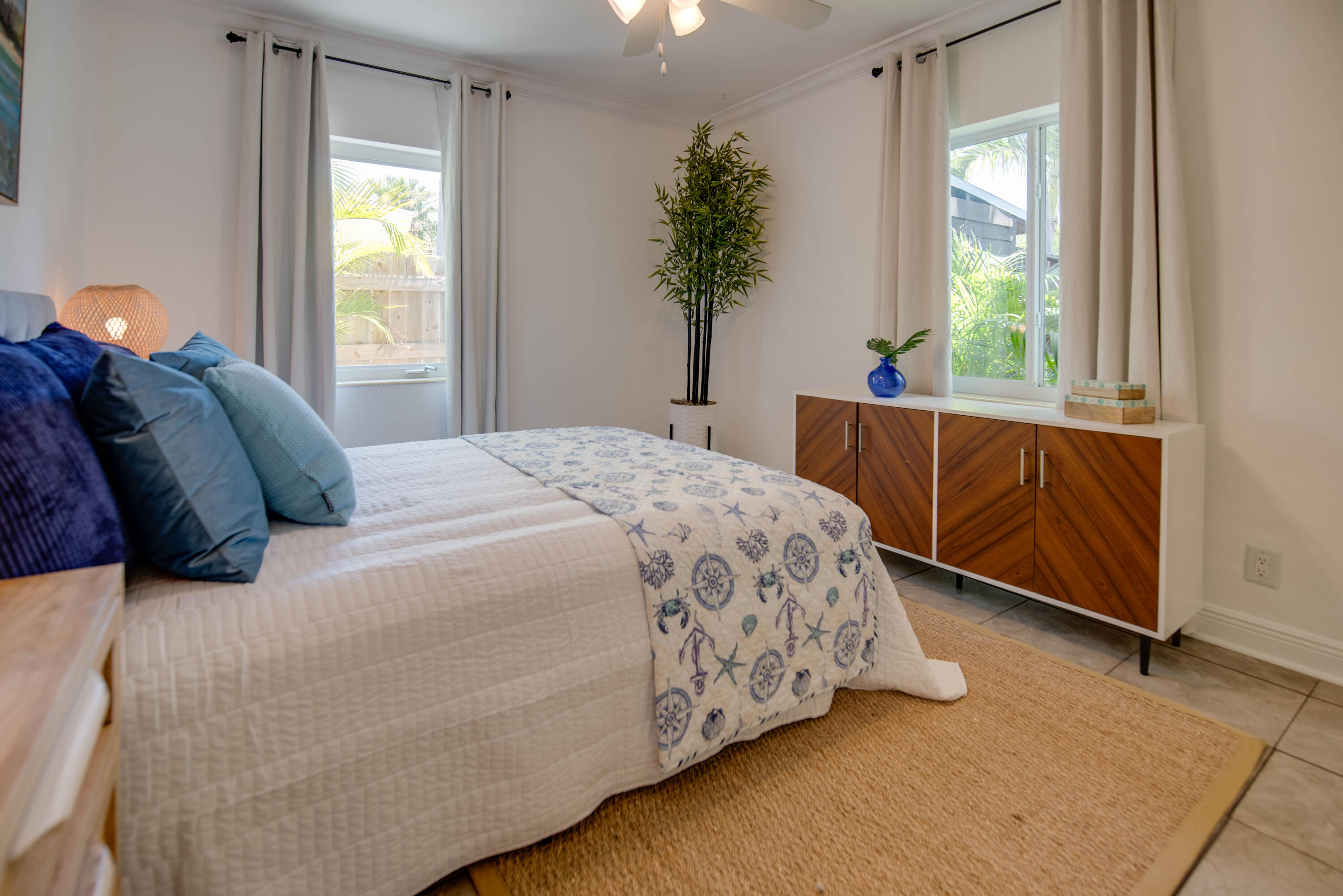a bedroom with a bed lamp and a window