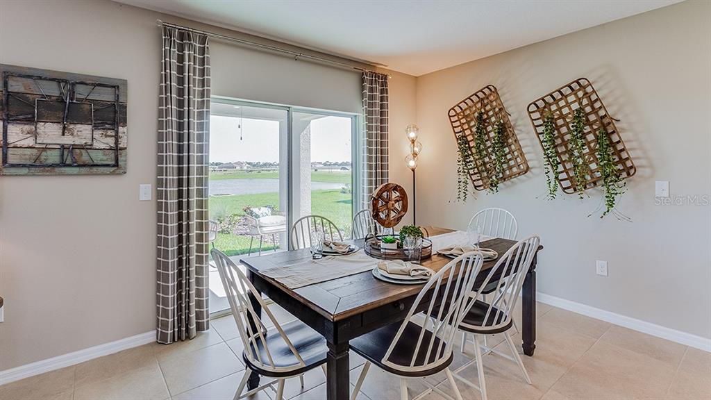 18114 Wheathouse Place Lakewood Ranch, FL 34211 - Photo 5 of 43 a view of a dining room with furniture window and outside view