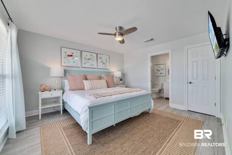 1492 Shell Lane Gulf Shores, AL 36542 - Photo 9 of 20 Bedroom featuring light wood finished floors, connected bathroom, and a ceiling fan