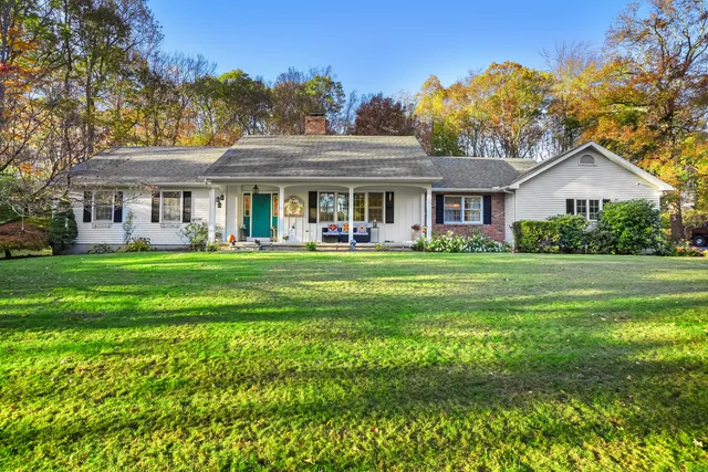 a front view of house with yard outdoor seating and green space