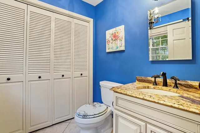 a bathroom with a toilet a sink and mirror