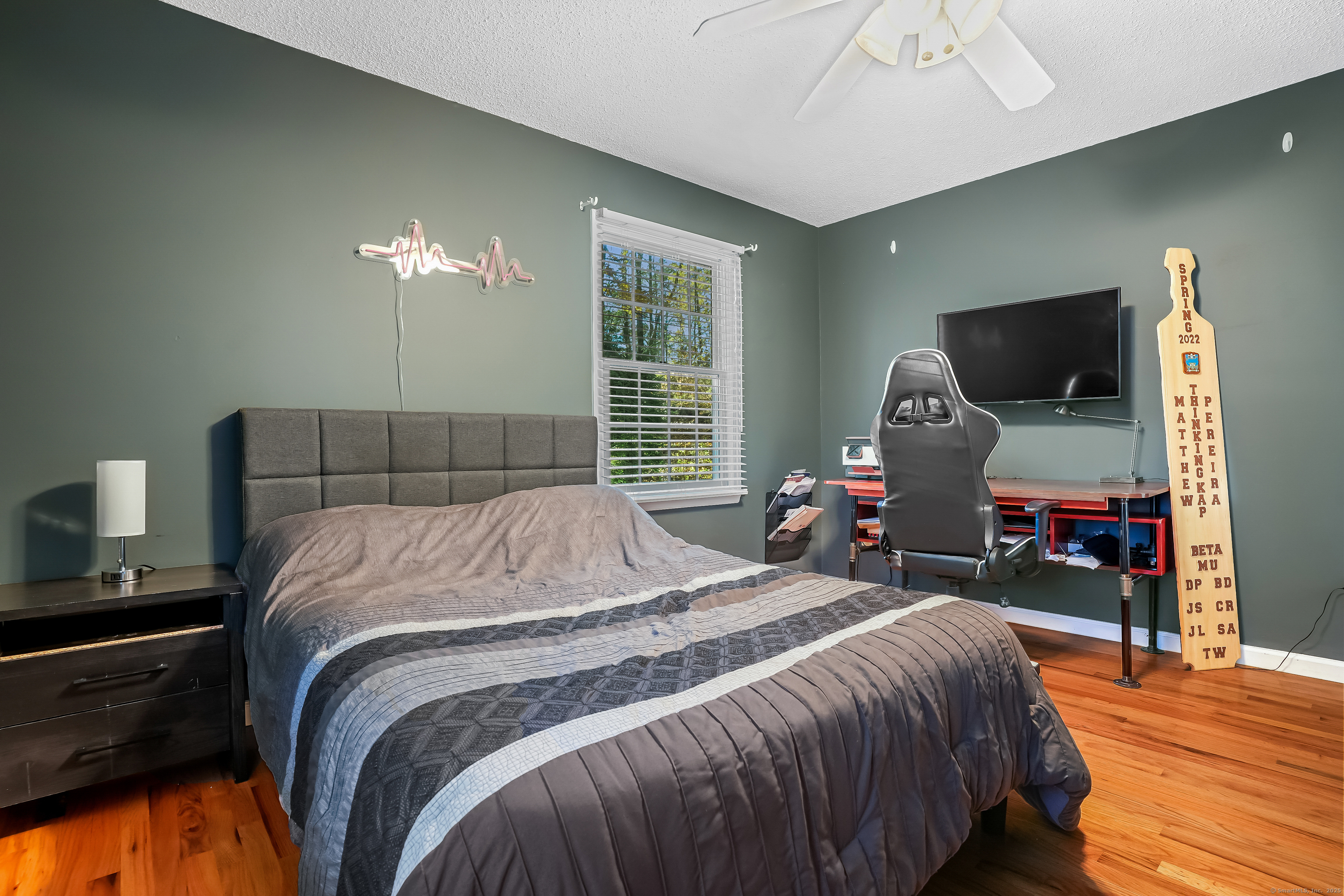 4 Autumn Ridge Road New Fairfield, CT 06812 - Photo 24 of 40 a bedroom with a bed and wooden floor