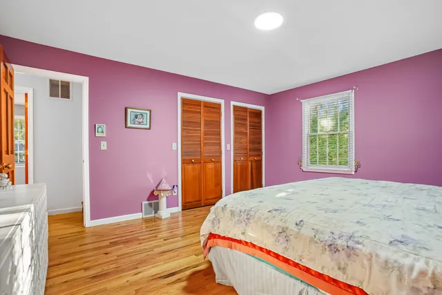 a bed room with a bed and wooden floor