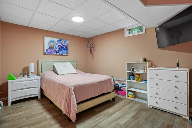 a bedroom with a bed and a television