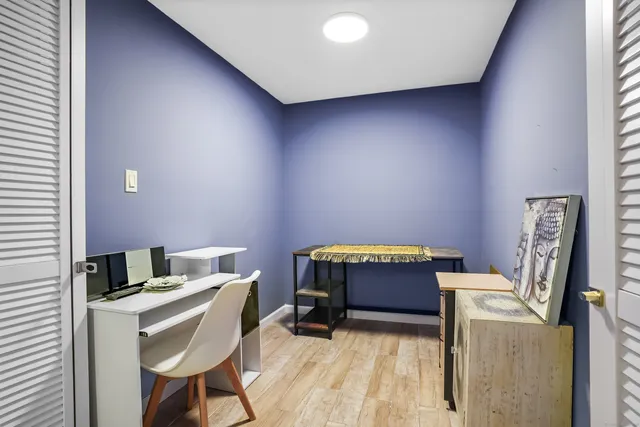 a bedroom with a chair and a window