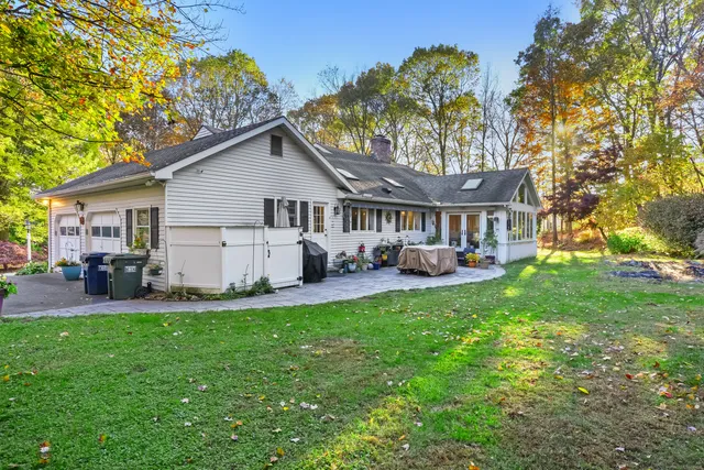 a view of a house with a yard and sitting area