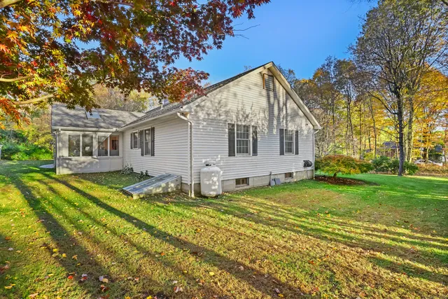 a view of a house with a backyard
