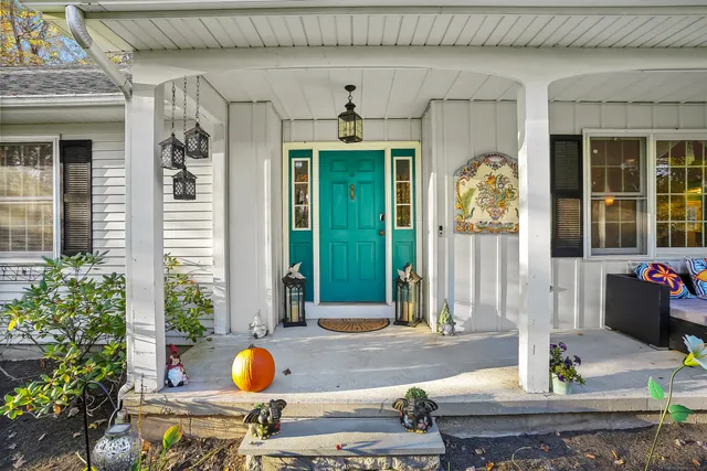 a front view of a house with outdoor seating and front door