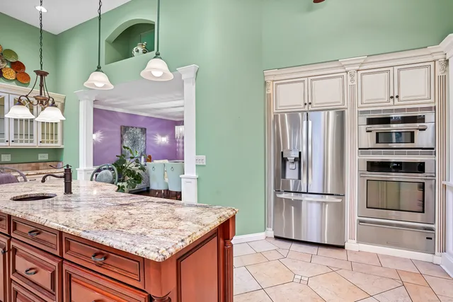 a kitchen with stainless steel appliances granite countertop a refrigerator and microwave
