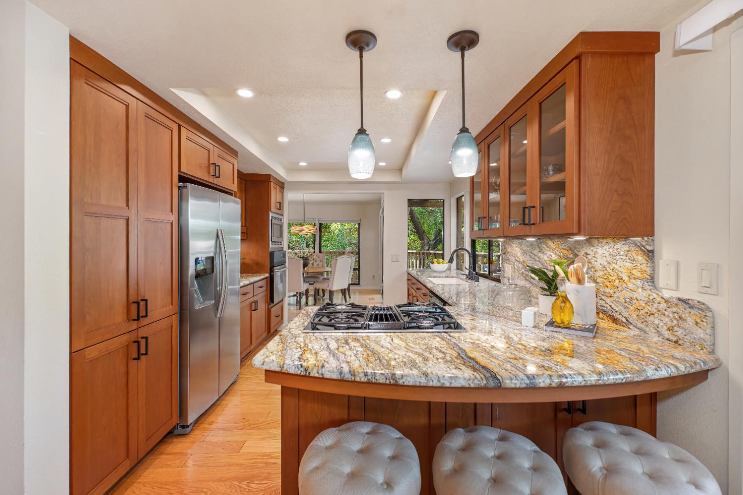 18 Covered Bridge Road Carmichael, CA 95608 - Photo 36 of 81 a kitchen with sink refrigerator dining table and chairs