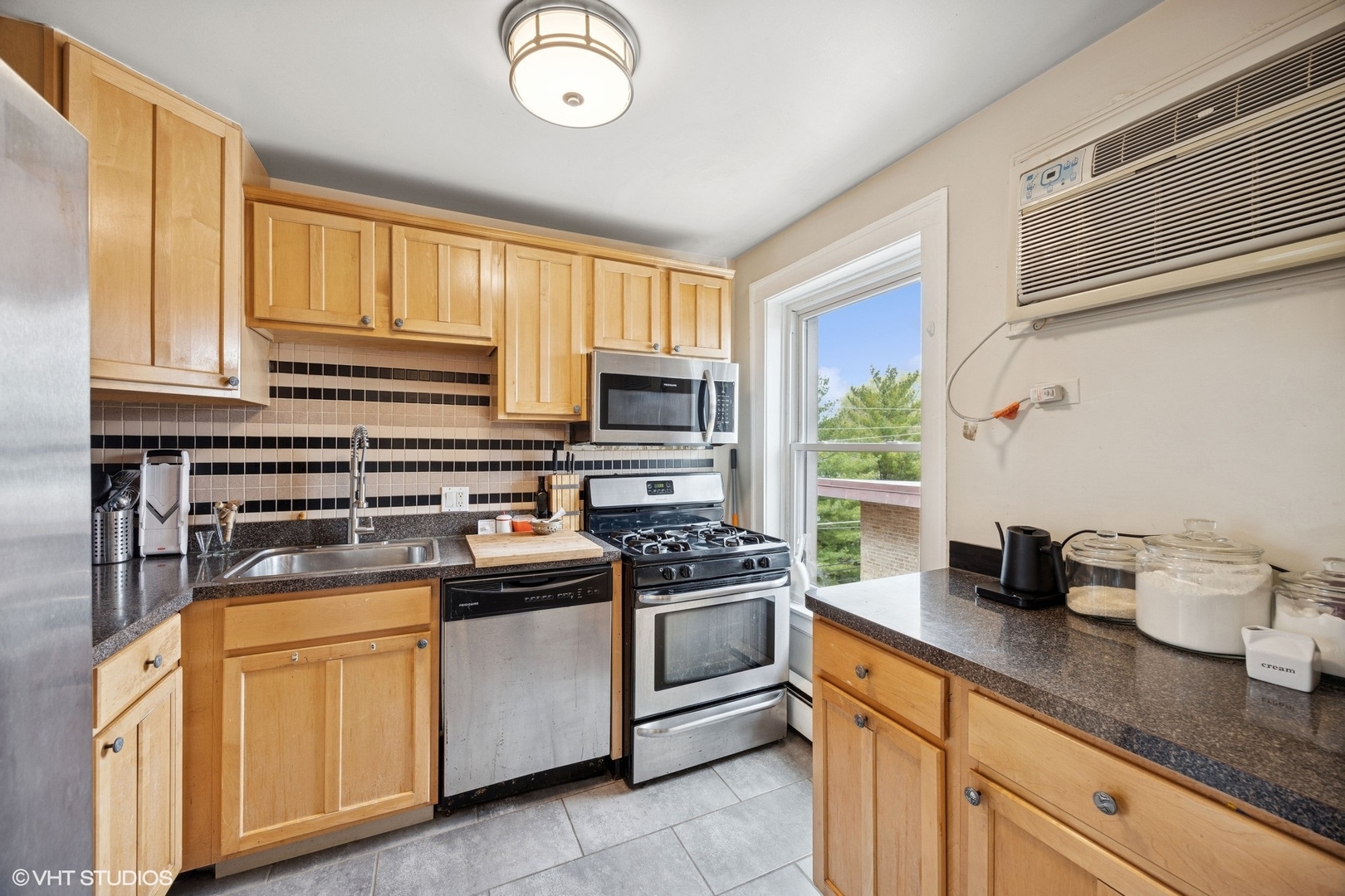 938 Washington Boulevard, Unit 3W Oak Park, IL 60302 - Photo 8 of 16 a kitchen with stainless steel appliances granite countertop a stove a sink and a microwave