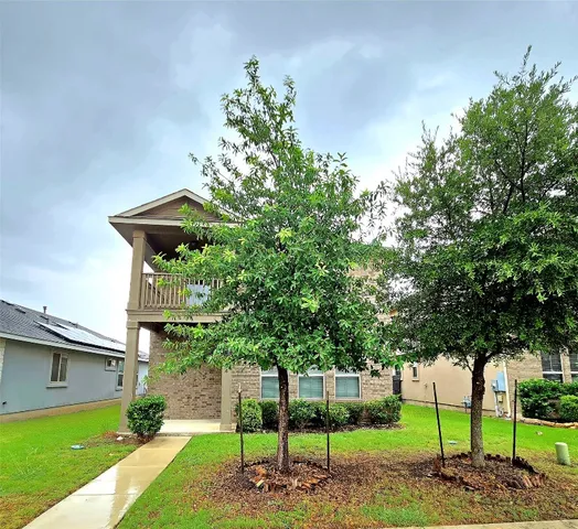 a green field with trees in front of it