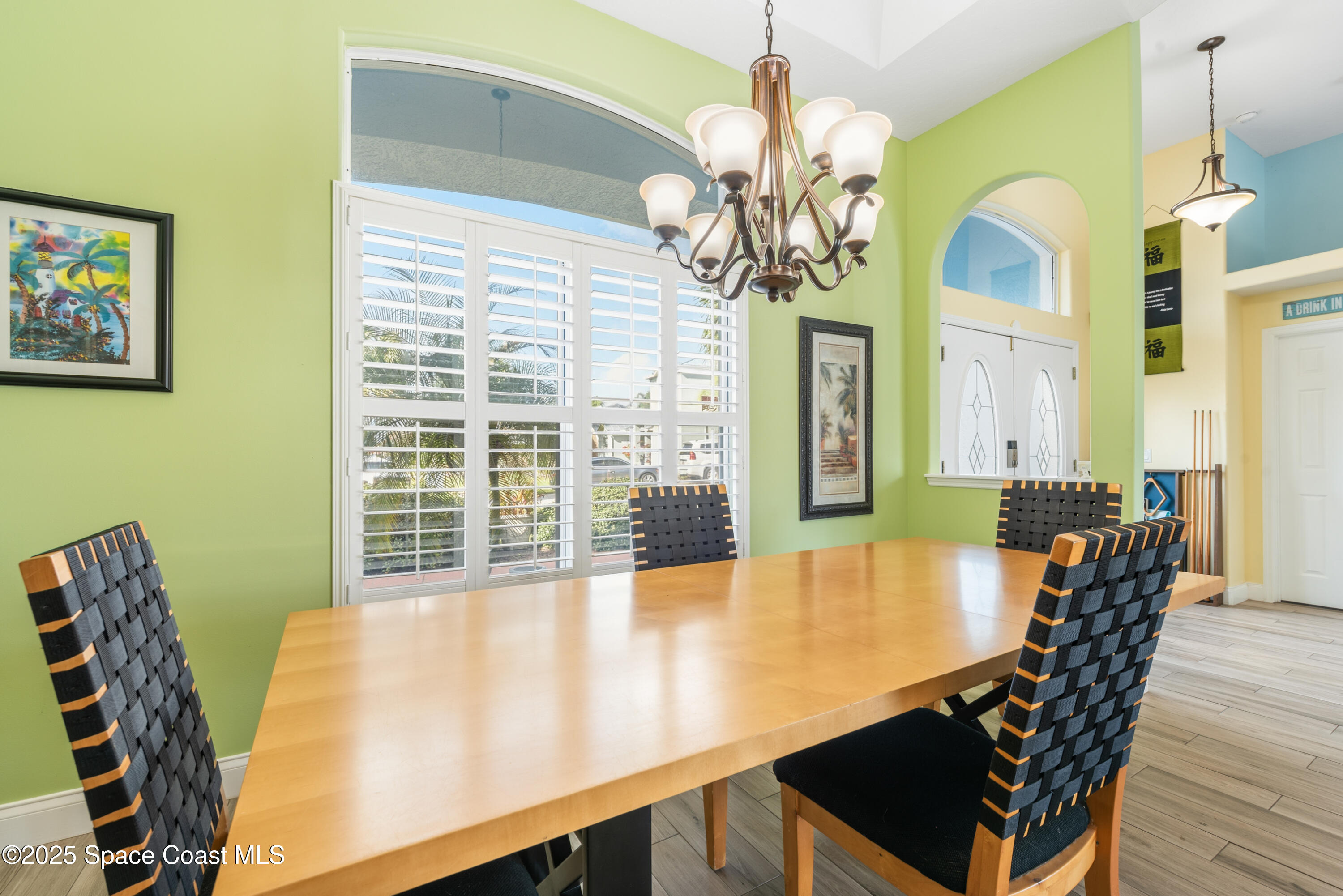452 Veracruz Boulevard Indialantic, FL 32903 - Photo 12 of 42 a view of a dining room with furniture wooden floor and chandelier