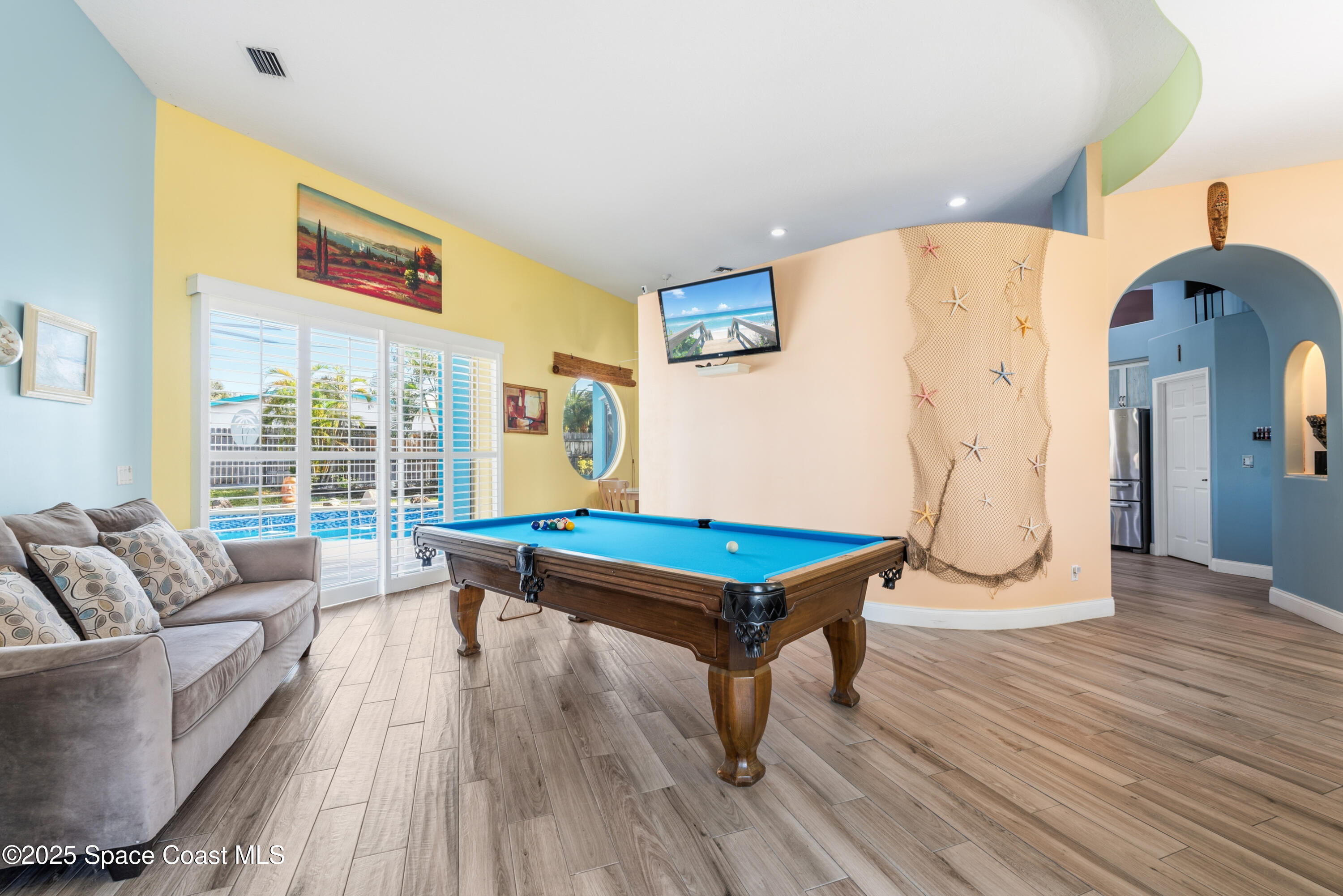 452 Veracruz Boulevard Indialantic, FL 32903 - Photo 14 of 42 a living room with furniture a table and wooden floor