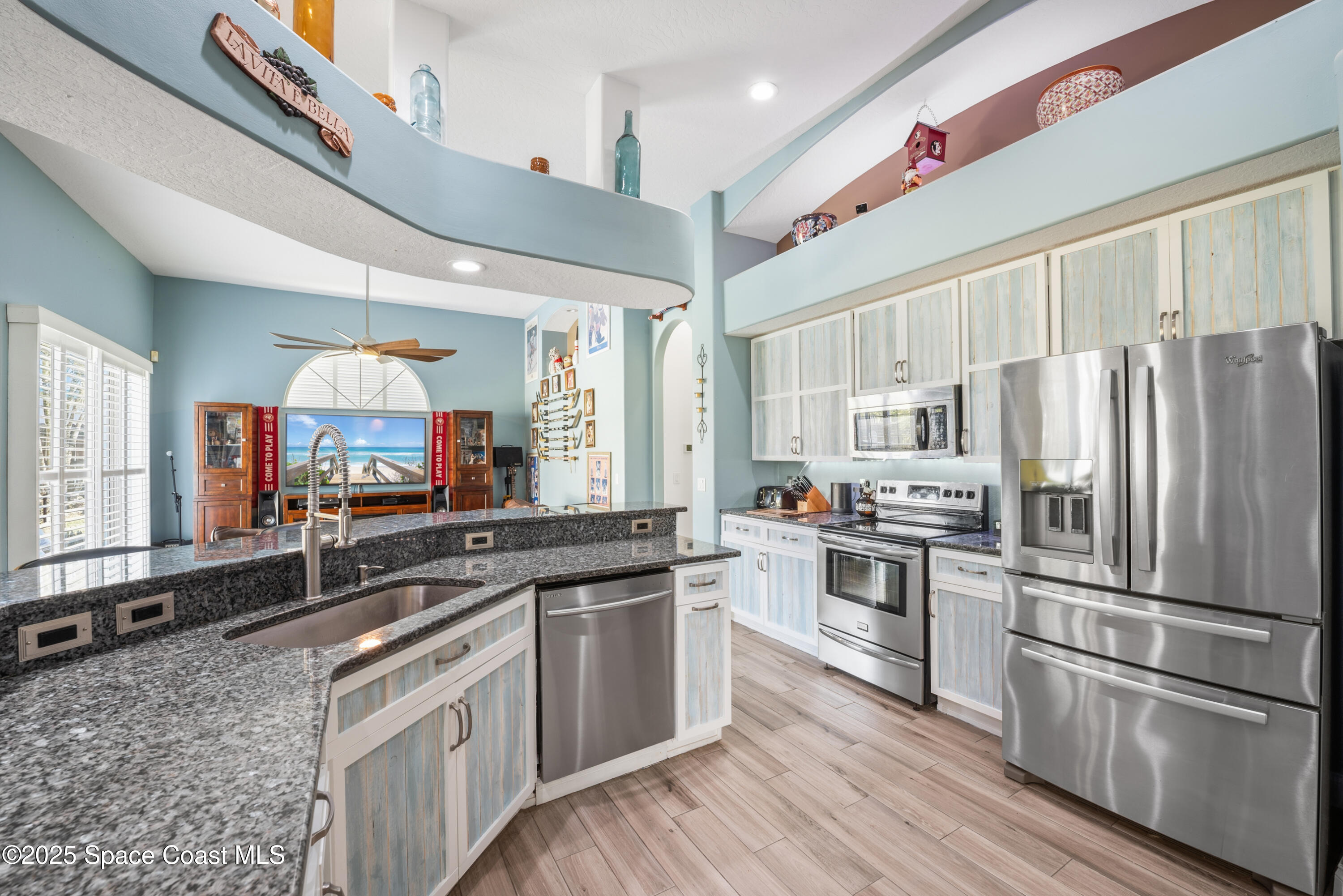 452 Veracruz Boulevard Indialantic, FL 32903 - Photo 16 of 42 a kitchen with stainless steel appliances a sink cabinets and wooden floor