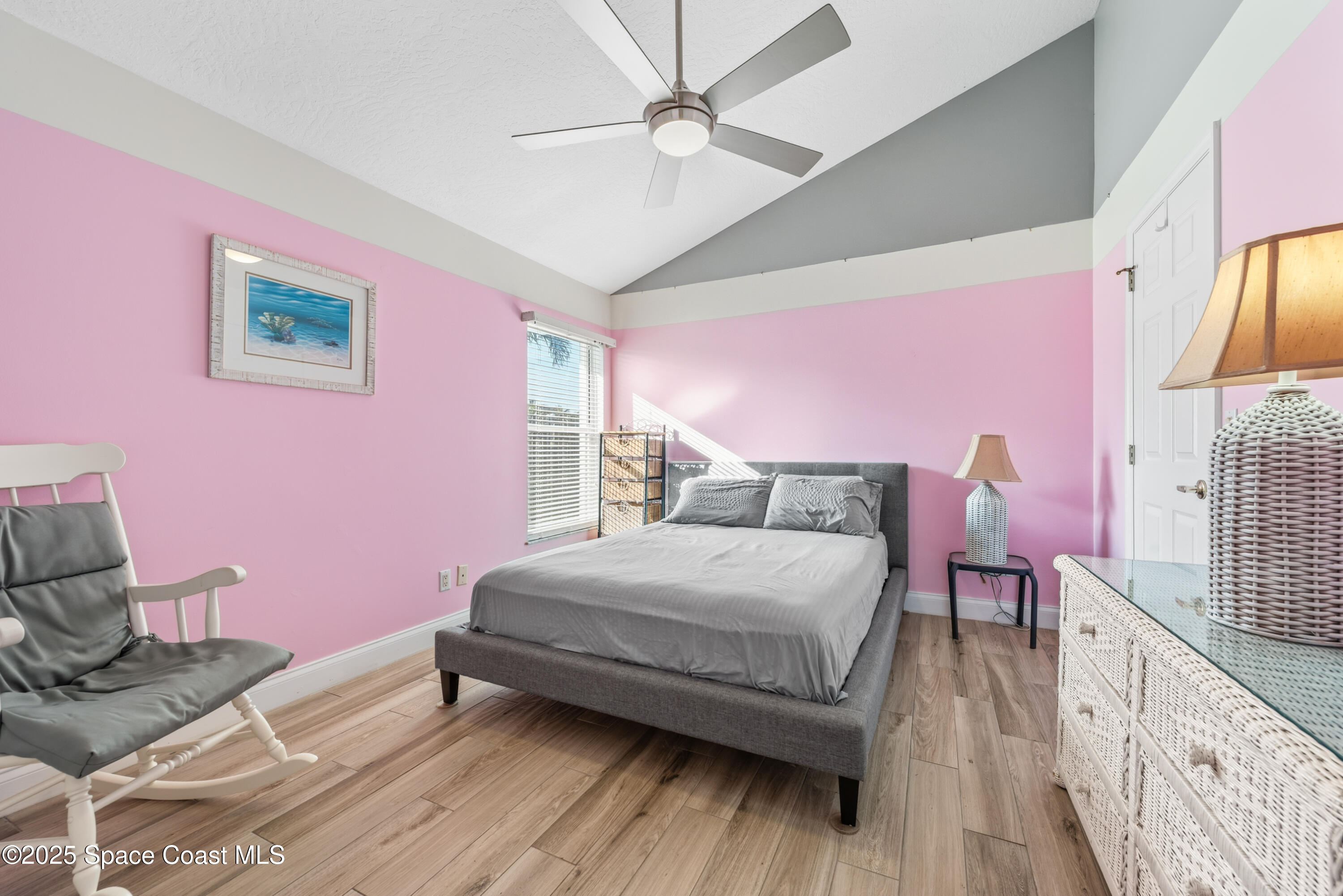 452 Veracruz Boulevard Indialantic, FL 32903 - Photo 20 of 42 a bedroom with a bed and a chandelier