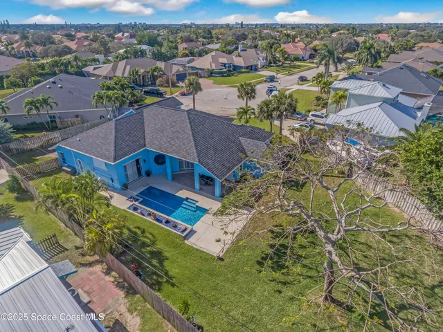 an aerial view of a house with a ocean view