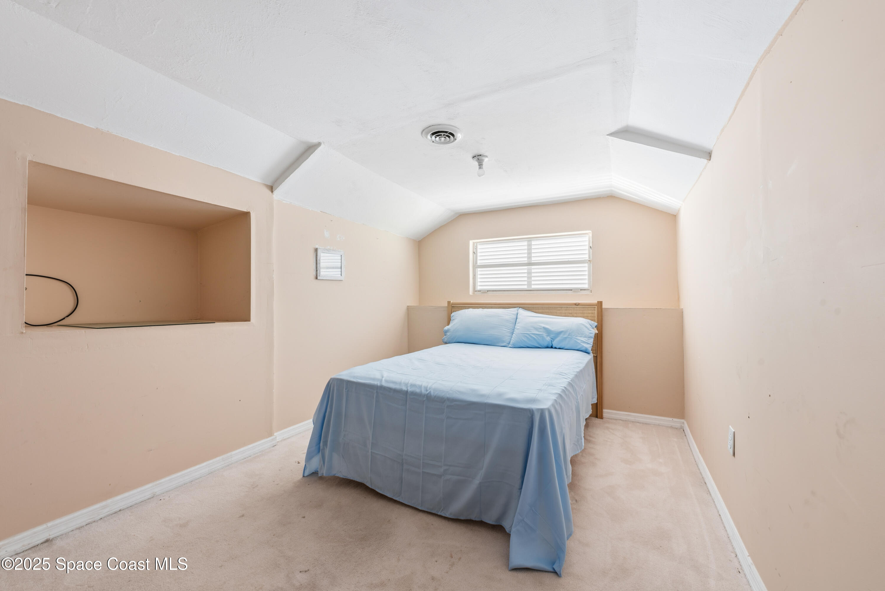 452 Veracruz Boulevard Indialantic, FL 32903 - Photo 34 of 42 a bedroom with a bed and a window