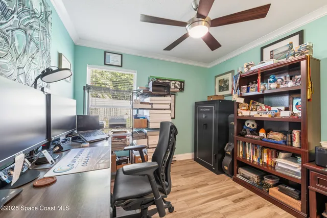 a view of a workspace with furniture and a bookshelf