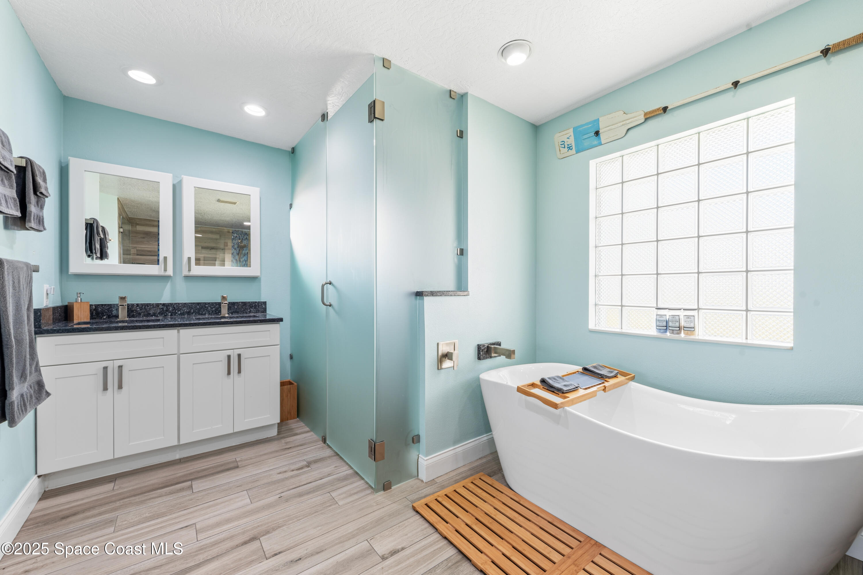 452 Veracruz Boulevard Indialantic, FL 32903 - Photo 10 of 42 a bathroom with a granite countertop sink and a bathtub