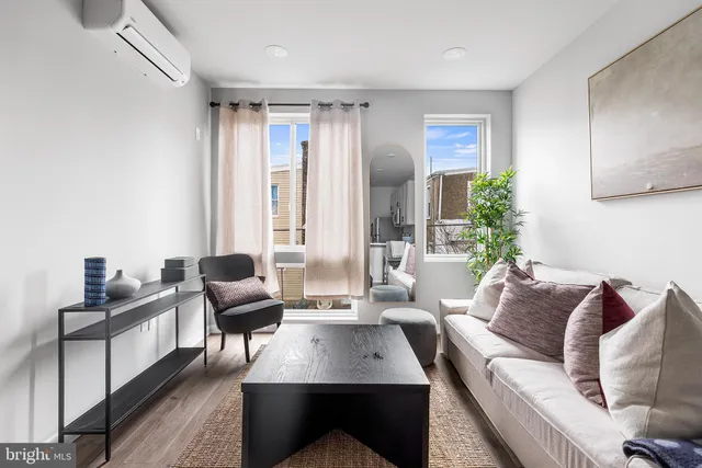 a living room with furniture lamp and window