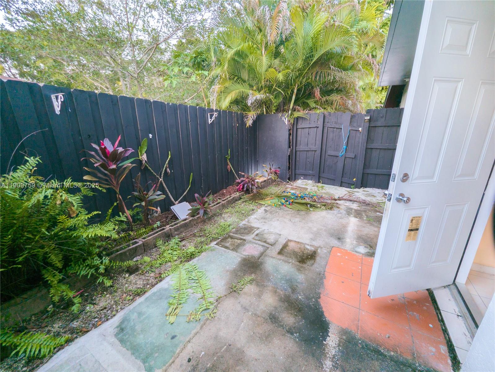 2575 Southwest 59th Avenue, Unit 2575 Miami, FL 33155 - Photo 12 of 21 a backyard with table and chairs a barbeque and a small yard
