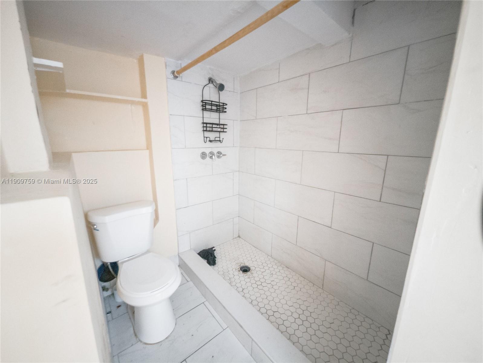 2575 Southwest 59th Avenue, Unit 2575 Miami, FL 33155 - Photo 14 of 21 a white toilet sitting next to a bathroom sink