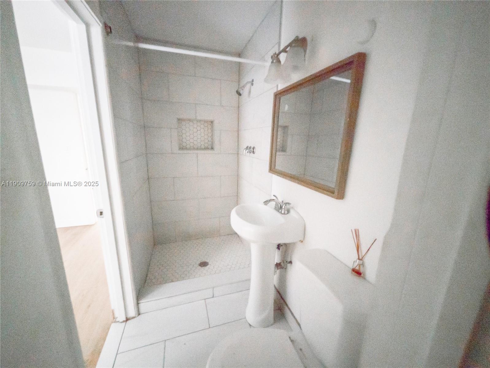 2575 Southwest 59th Avenue, Unit 2575 Miami, FL 33155 - Photo 19 of 21 a bathroom with a shower and mirror