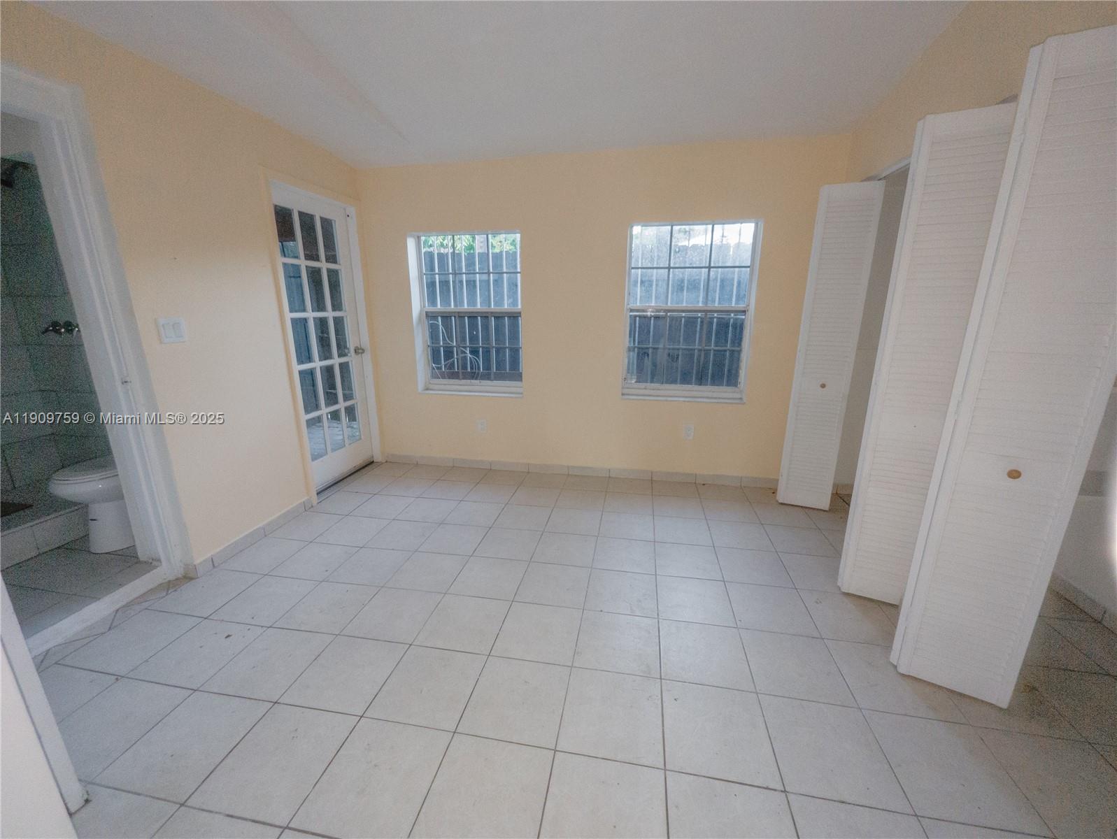 2575 Southwest 59th Avenue, Unit 2575 Miami, FL 33155 - Photo 6 of 21 a view of an empty room with a window