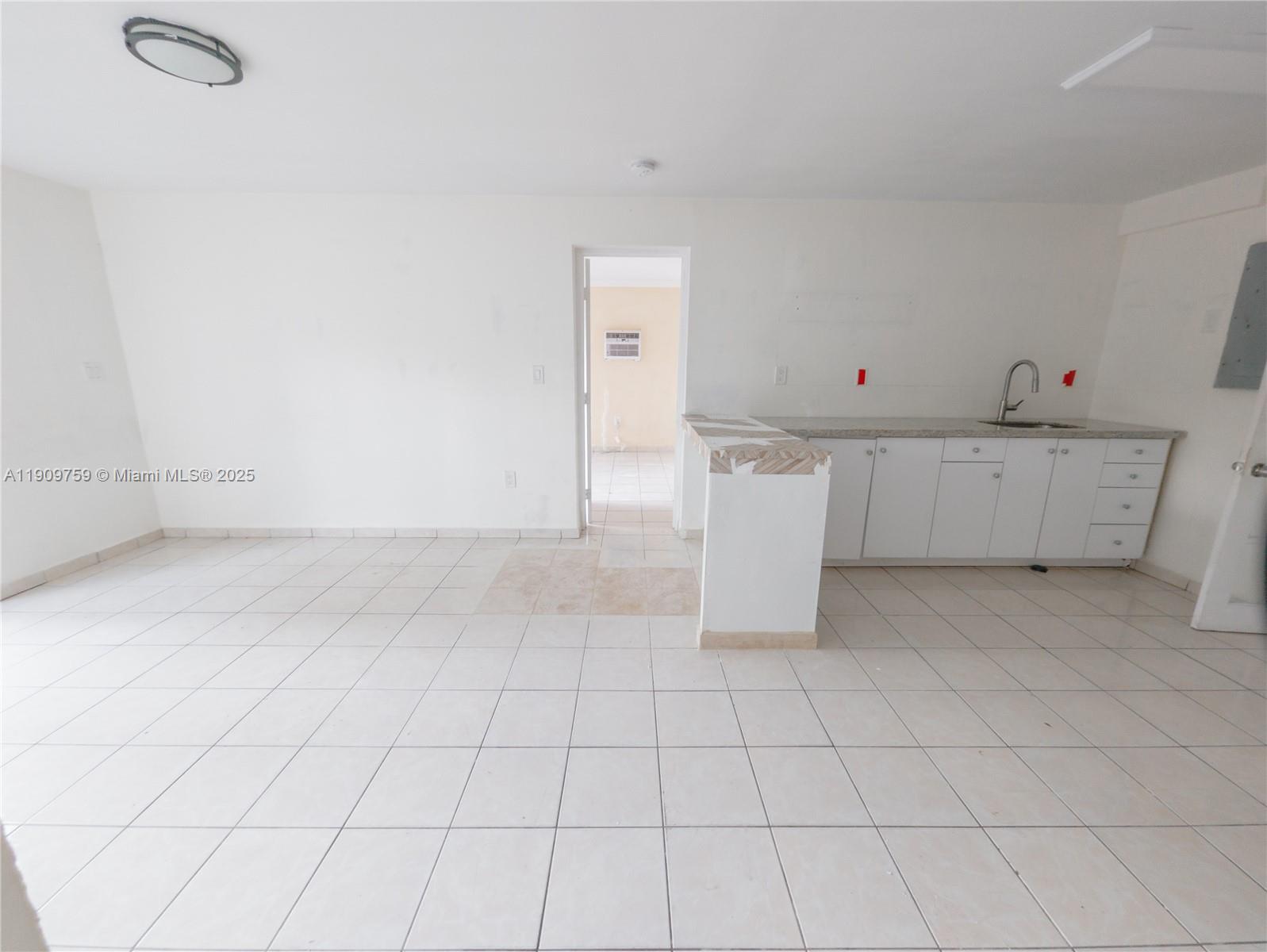 2575 Southwest 59th Avenue, Unit 2575 Miami, FL 33155 - Photo 10 of 21 a view of a kitchen with white cabinets