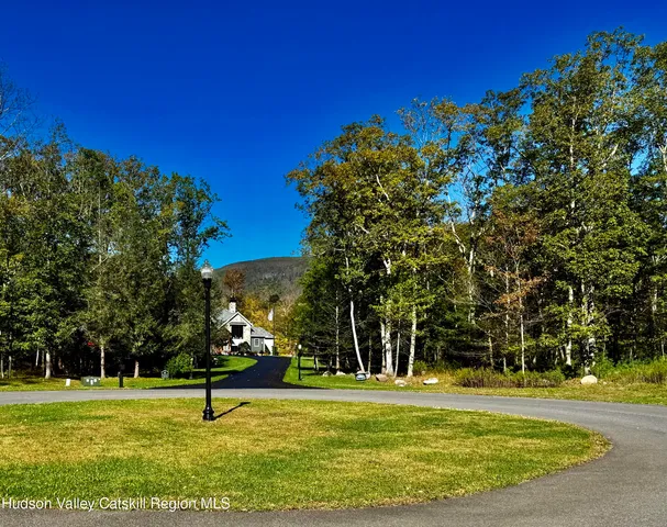 a backyard of a house with lots of plants and trees