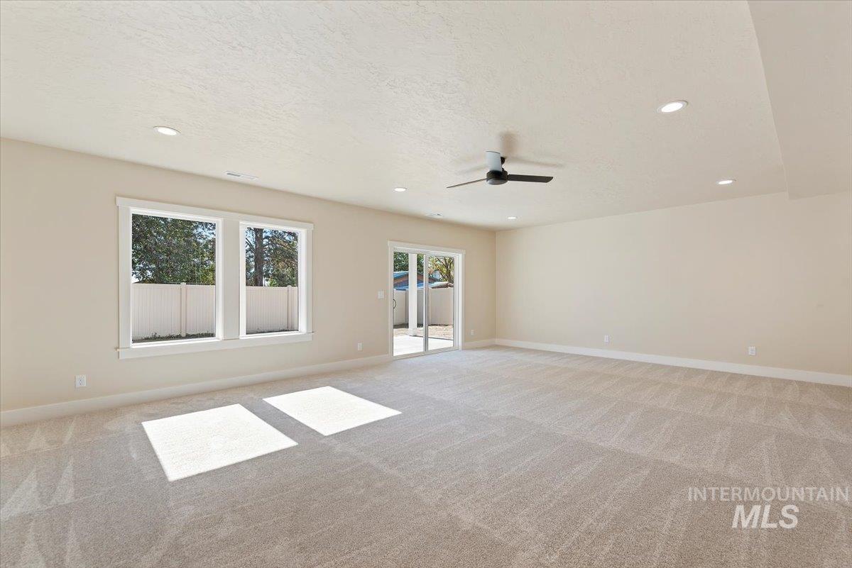 1300 Birch Street Parma, ID 83660 - Photo 13 of 25 Empty room featuring light colored carpet, recessed lighting, a textured ceiling, and a ceiling fan