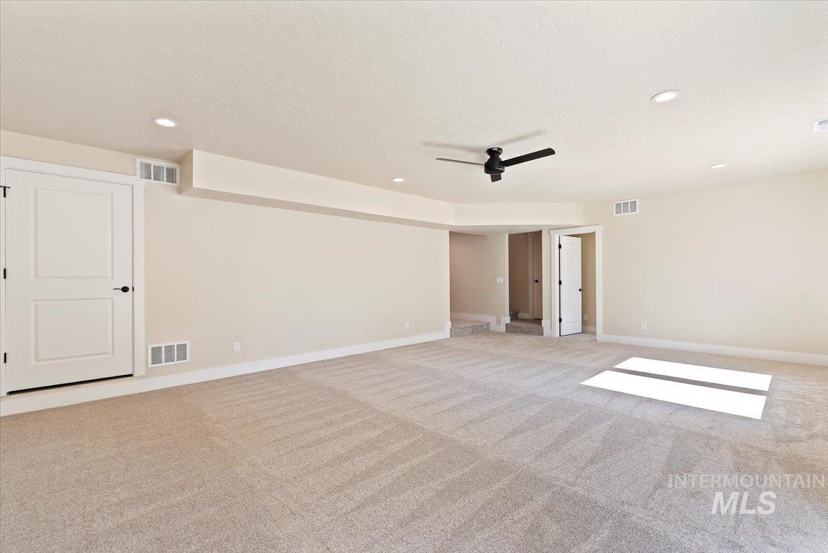 1300 Birch Street Parma, ID 83660 - Photo 14 of 25 Unfurnished room featuring light carpet, recessed lighting, ceiling fan, and a textured ceiling