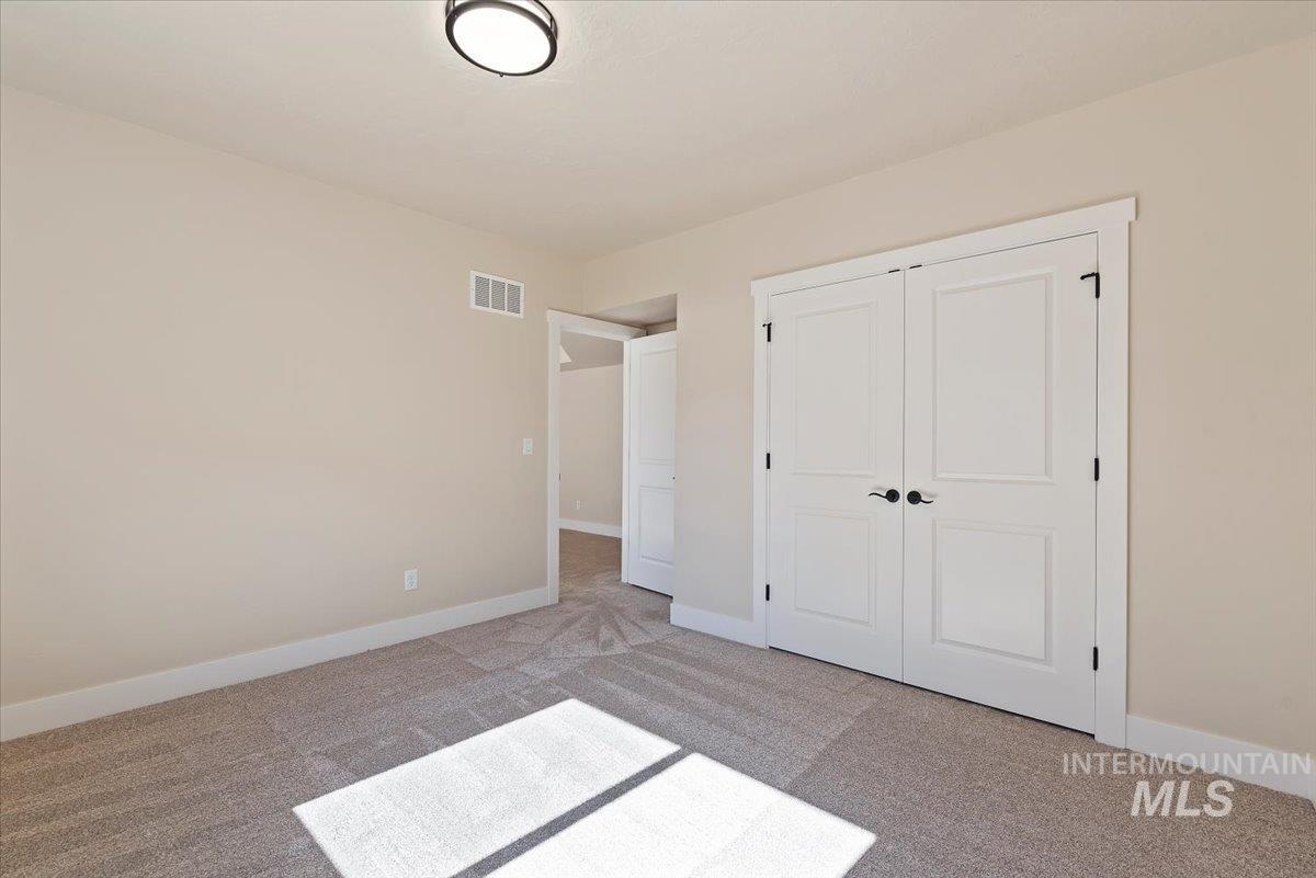 1300 Birch Street Parma, ID 83660 - Photo 15 of 24 Unfurnished bedroom with carpet and a closet