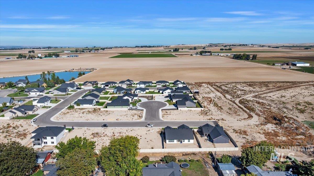1300 Birch Street Parma, ID 83660 - Photo 2 of 25 Aerial view of property and surrounding area featuring nearby suburban area and a large body of water