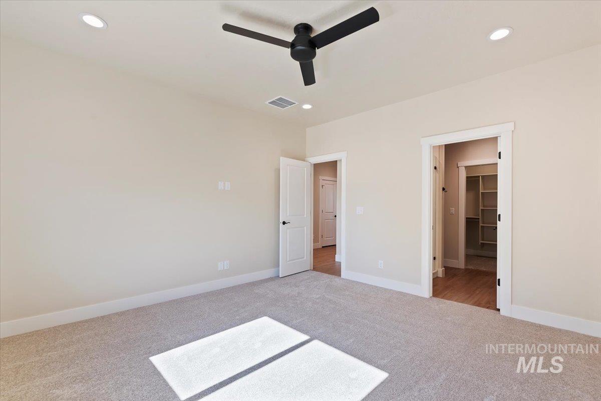 1300 Birch Street Parma, ID 83660 - Photo 8 of 25 Unfurnished bedroom with light carpet, ceiling fan, recessed lighting, and connected bathroom