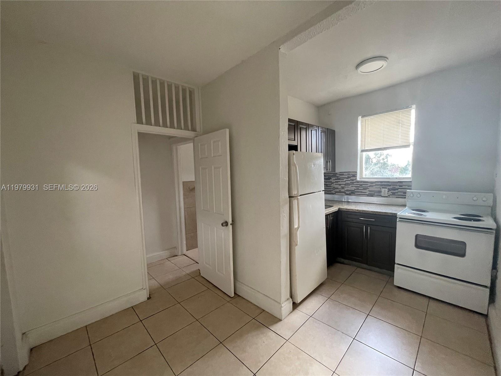 a kitchen with a stove sink and refrigerator