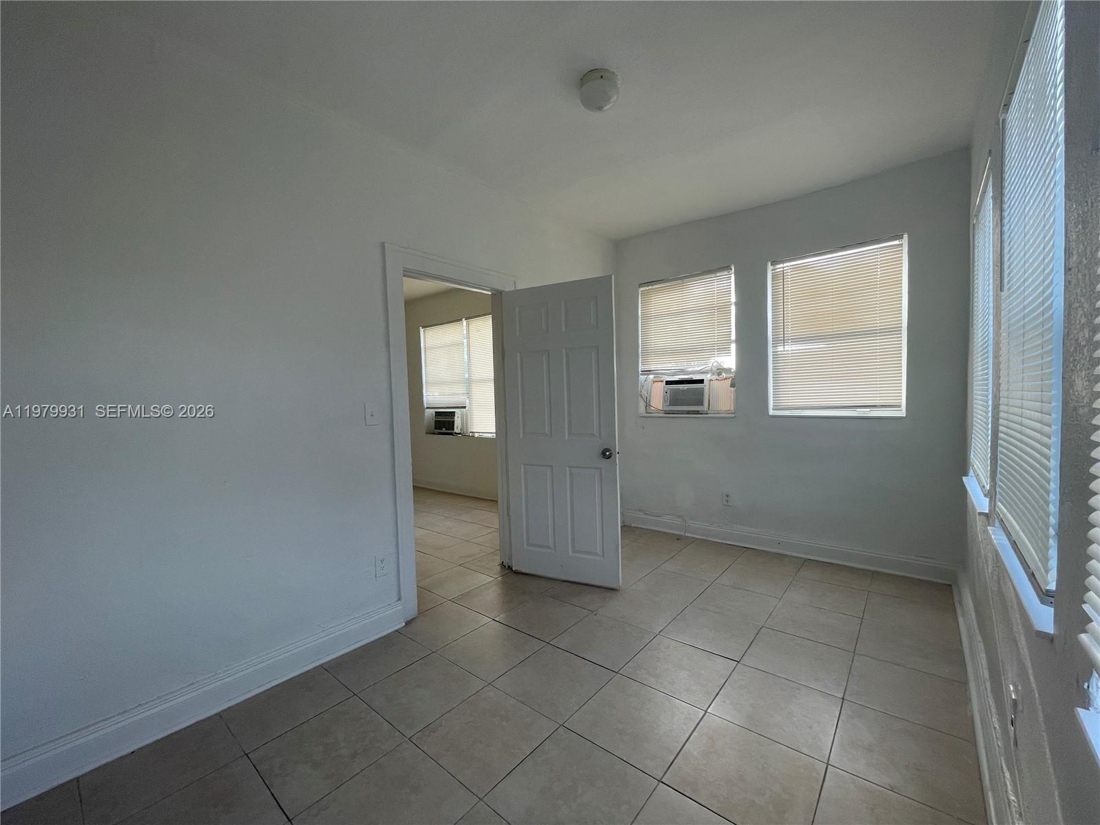 1060 Northwest 47th Street, Unit 5 Miami, FL 33127 - Photo 11 of 19 an empty room with windows