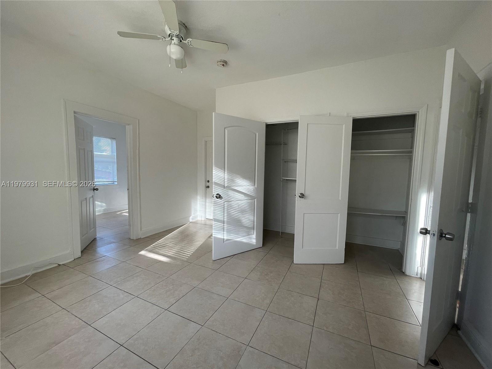 1060 Northwest 47th Street, Unit 5 Miami, FL 33127 - Photo 14 of 19 a view of a bathroom with a shower and a sink