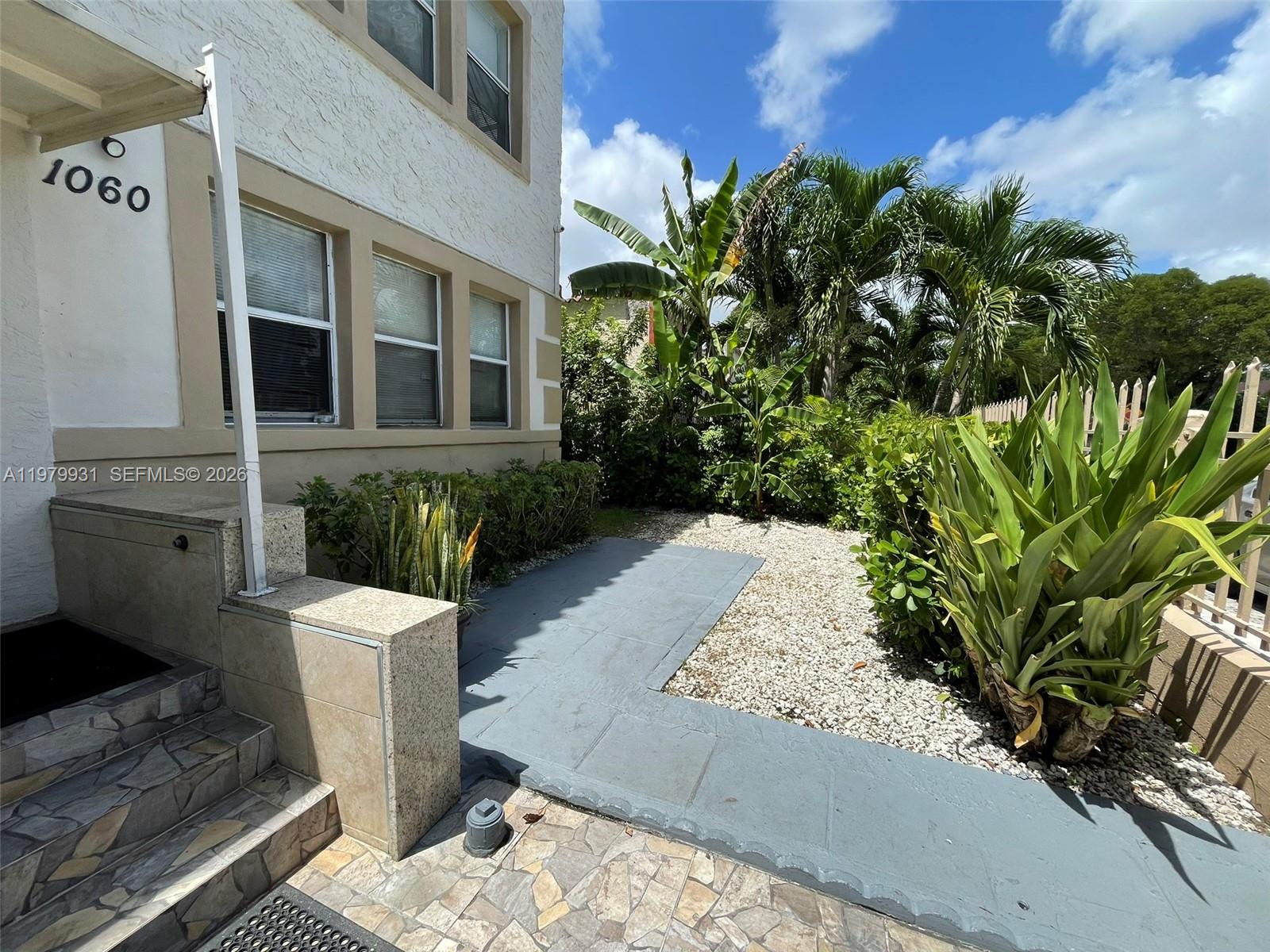 1060 Northwest 47th Street, Unit 5 Miami, FL 33127 - Photo 15 of 19 a view of a backyard with plants