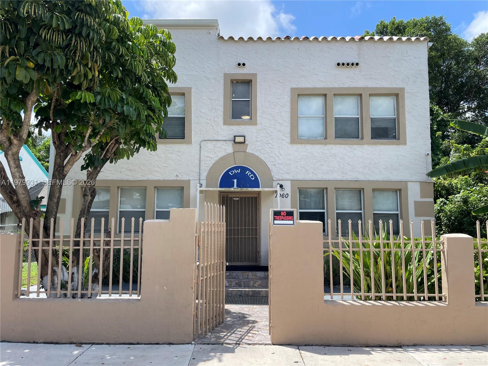 1060 Northwest 47th Street, Unit 5 Miami, FL 33127 - Photo 16 of 19 a front view of a house with a garden