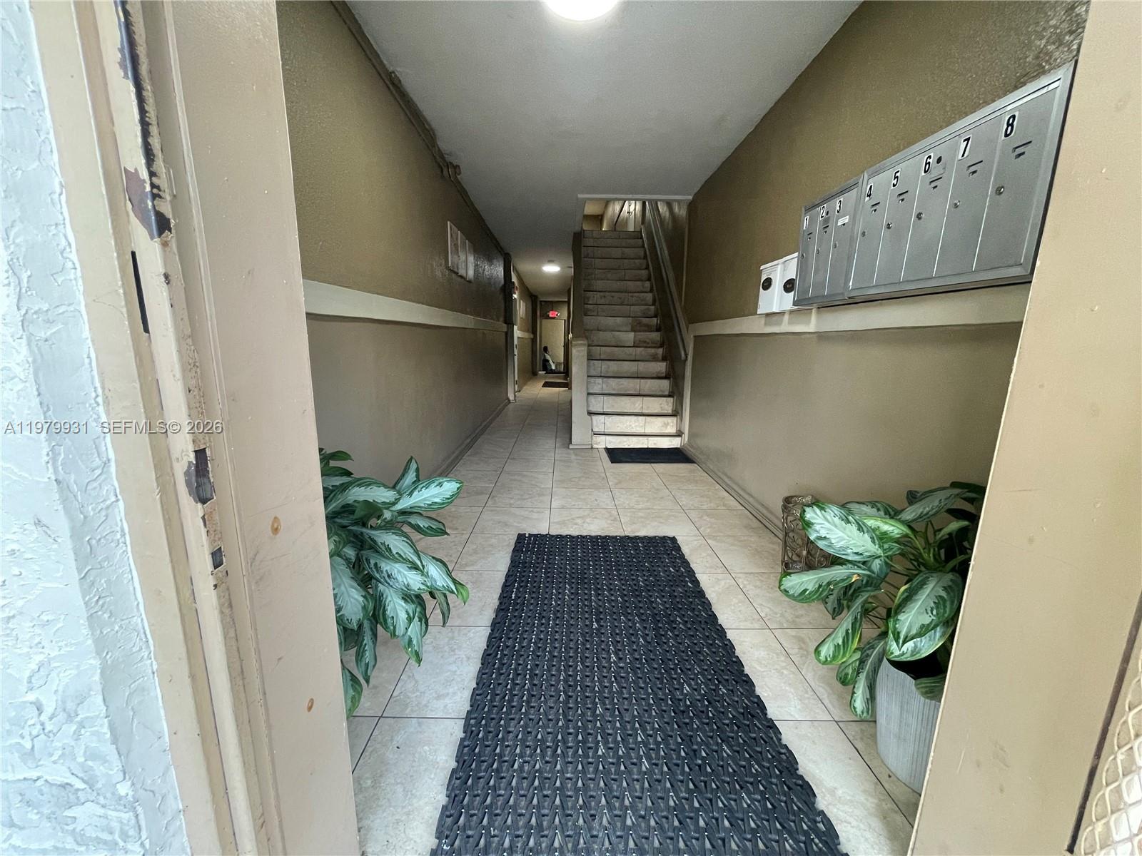1060 Northwest 47th Street, Unit 5 Miami, FL 33127 - Photo 2 of 19 a view of entryway with wooden floor