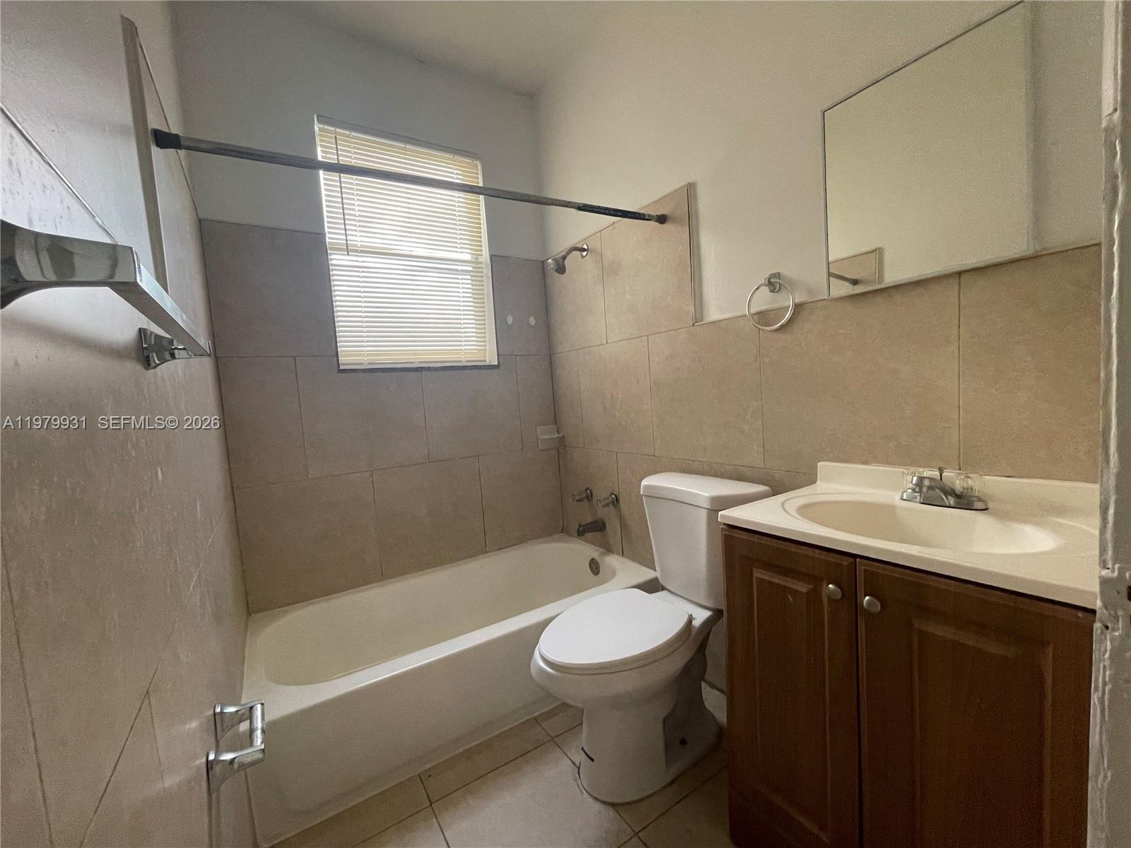 1060 Northwest 47th Street, Unit 5 Miami, FL 33127 - Photo 7 of 19 a bathroom with a sink toilet and shower