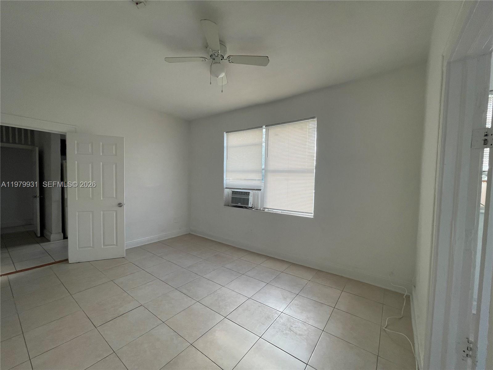 1060 Northwest 47th Street, Unit 5 Miami, FL 33127 - Photo 9 of 19 an empty room with a empty space and windows