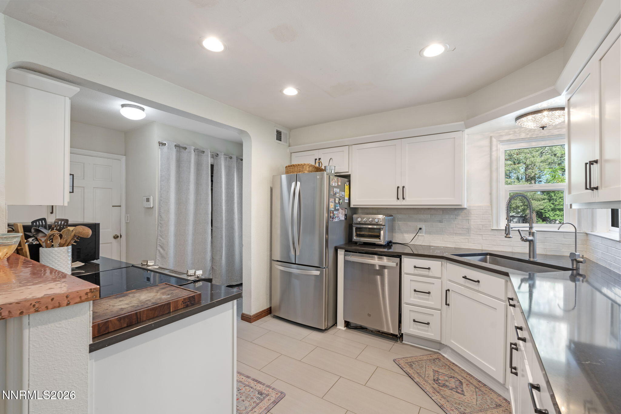 300 Country Club Drive Reno, NV 89509 - Photo 18 of 48 a kitchen with stainless steel appliances granite countertop a sink and a refrigerator
